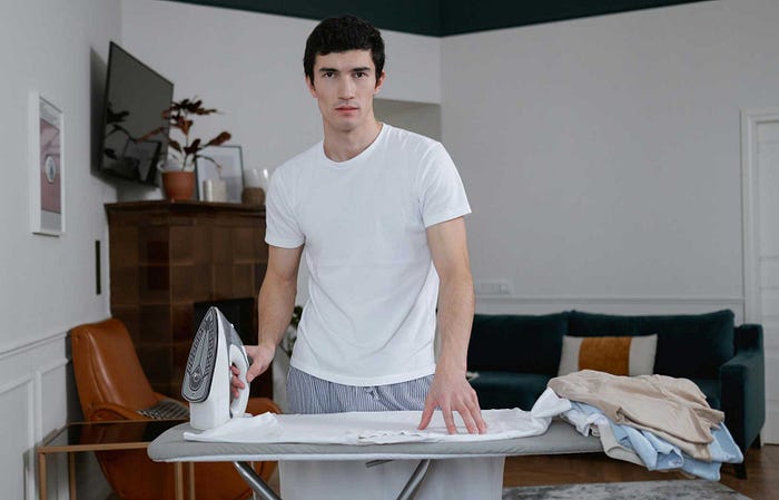 Man doing ironing housework